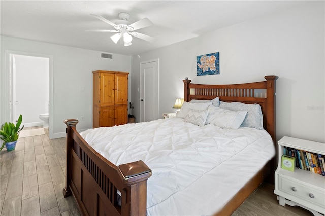 157 Pinehurst Dr Unit 157, Bradenton, FL 34210 - bedroom featuring wood finished floors, ensuite bathroom, ceiling fan, and baseboards