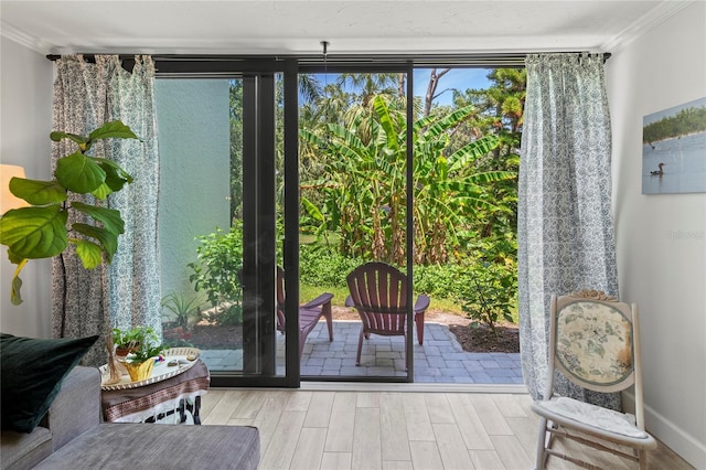 157 Pinehurst Dr Unit 157, Bradenton, FL 34210 - doorway to outside featuring crown molding and wood finished floors