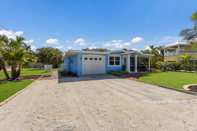 ranch-style home featuring driveway, an attached garage, stucco siding, and a front lawn