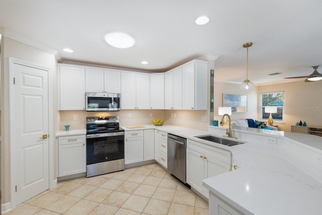 kitchen with stainless steel appliances, ornamental molding, a sink, light tile patterned flooring, and a peninsula