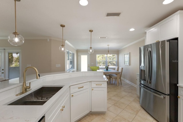 kitchen with stainless steel fridge with ice dispenser, a sink, ornamental molding, white cabinets, and pendant lighting