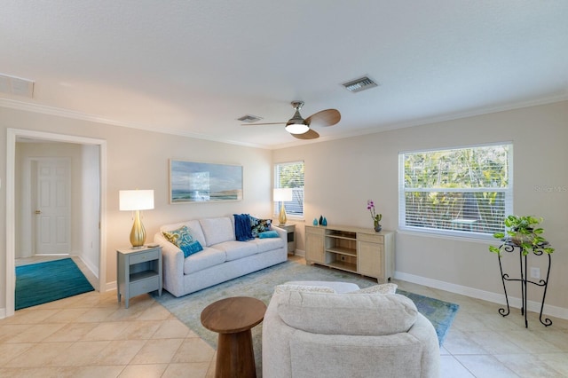 living room with light tile patterned floors, crown molding, ceiling fan, and baseboards