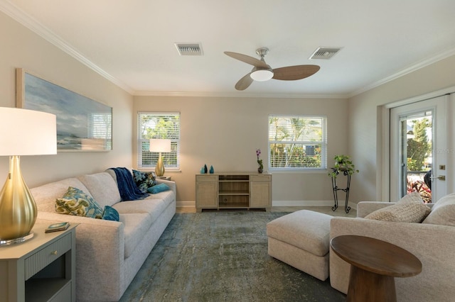 living area featuring ornamental molding, baseboards, and ceiling fan