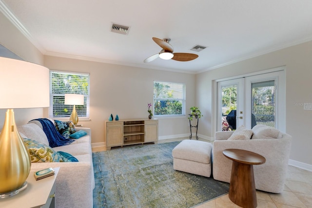tiled living room featuring ornamental molding, french doors, ceiling fan, healthy amount of natural light, and baseboards