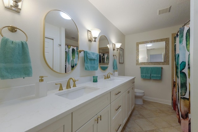 full bath featuring double vanity, toilet, tile patterned floors, and baseboards