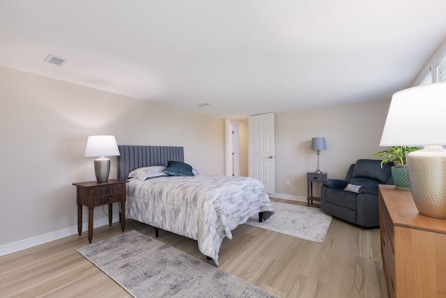 bedroom with light wood-style floors and baseboards