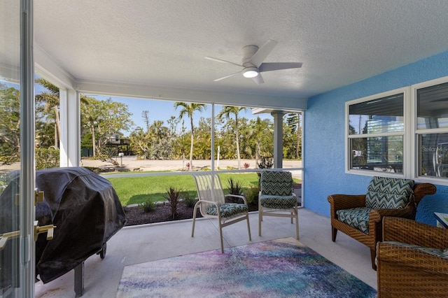 sunroom / solarium with a ceiling fan and plenty of natural light