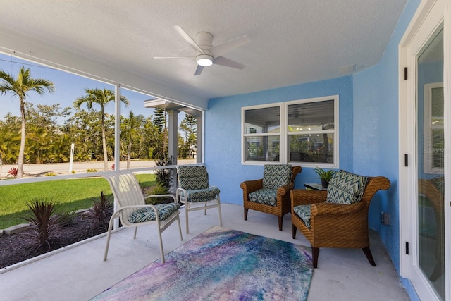 sunroom / solarium with a ceiling fan