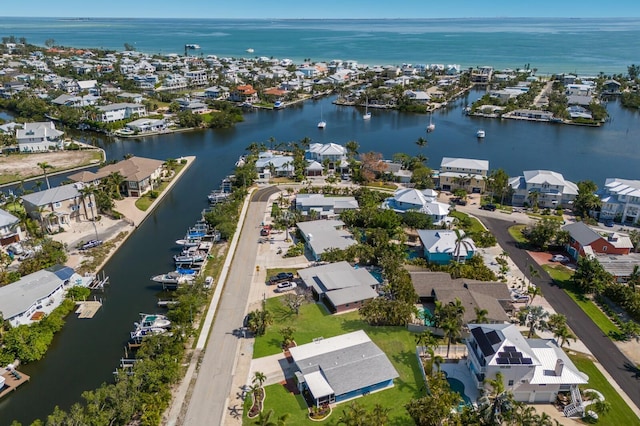 aerial overview of property's location with nearby suburban area and a large body of water