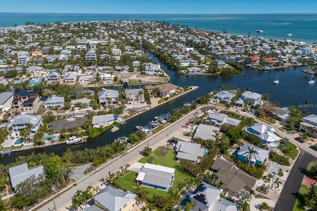 view of property location featuring a nearby body of water and nearby suburban area