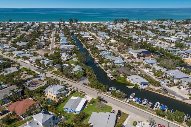 aerial view of property's location featuring a large body of water and nearby suburban area