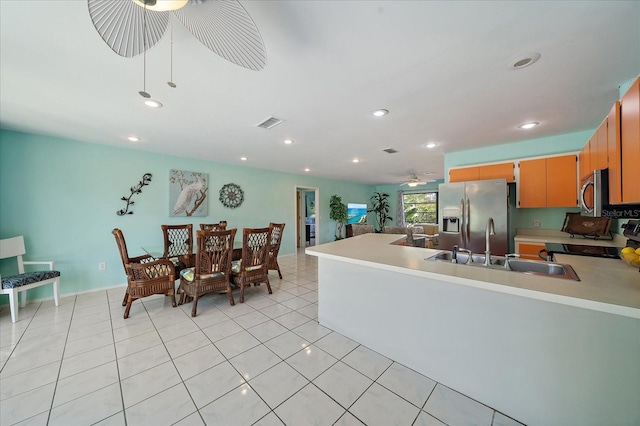9089 Berendo Ave, Englewood, FL 34224 - kitchen with ceiling fan, stainless steel appliances, a sink, light countertops, and a peninsula