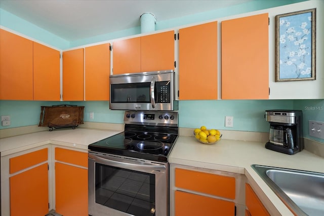 9089 Berendo Ave, Englewood, FL 34224 - kitchen featuring stainless steel appliances, light countertops, and a sink