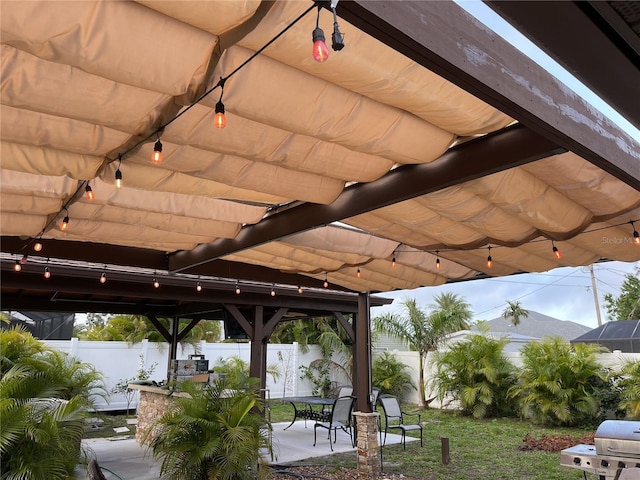 9089 Berendo Ave, Englewood, FL 34224 - fenced backyard with a patio, grilling area, and outdoor dining area