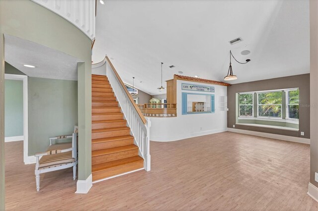 919 Palm View Way, Sarasota, FL 34240 - unfurnished living room featuring stairway, wood finished floors, and baseboards