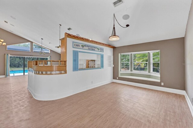 919 Palm View Way, Sarasota, FL 34240 - unfurnished living room featuring baseboards, a chandelier, high vaulted ceiling, and wood finished floors