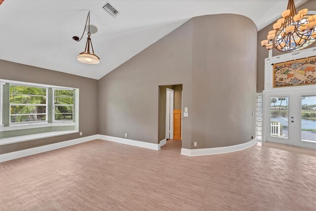 919 Palm View Way, Sarasota, FL 34240 - unfurnished room featuring high vaulted ceiling, a chandelier, healthy amount of natural light, baseboards, and a water view