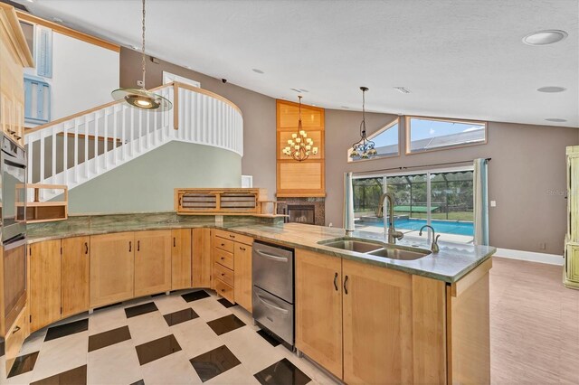 919 Palm View Way, Sarasota, FL 34240 - kitchen with a sink, lofted ceiling, light flooring, a peninsula, and light brown cabinets