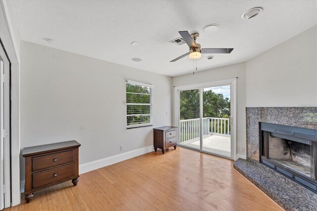 919 Palm View Way, Sarasota, FL 34240 - unfurnished living room featuring baseboards, light wood-type flooring, a high end fireplace, and a ceiling fan