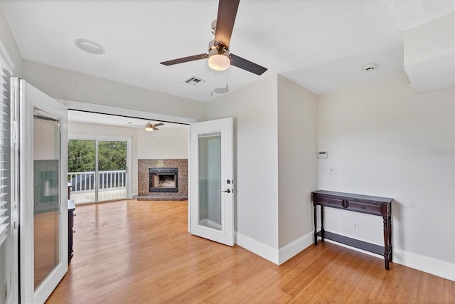 919 Palm View Way, Sarasota, FL 34240 - unfurnished living room featuring a ceiling fan, baseboards, light wood-style floors, and a fireplace with raised hearth
