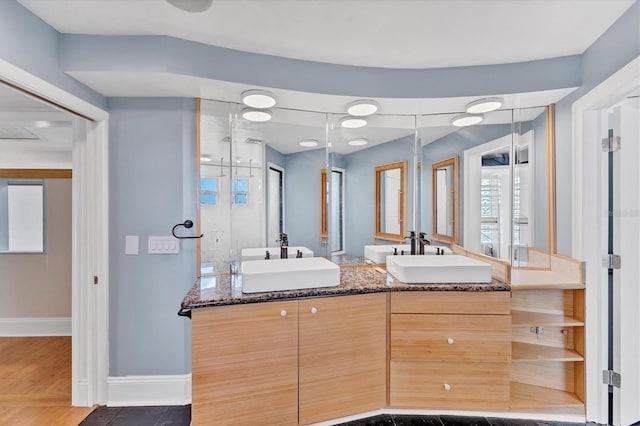 919 Palm View Way, Sarasota, FL 34240 - bathroom with baseboards, a shower stall, and double vanity