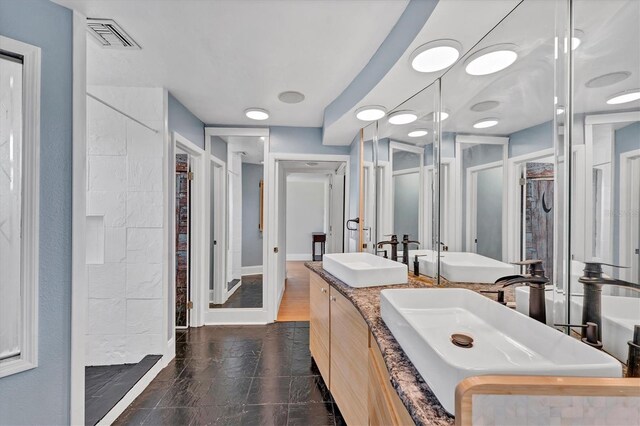 919 Palm View Way, Sarasota, FL 34240 - bathroom with a tile shower, double vanity, and a closet
