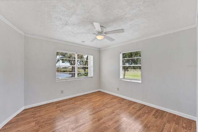 919 Palm View Way, Sarasota, FL 34240 - spare room with wood finished floors, baseboards, ceiling fan, ornamental molding, and a textured ceiling