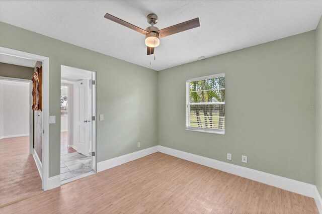 919 Palm View Way, Sarasota, FL 34240 - unfurnished bedroom with wood finished floors, baseboards, and ceiling fan