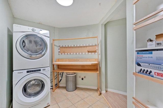 919 Palm View Way, Sarasota, FL 34240 - laundry room with stacked washer and clothes dryer, baseboards, and tile patterned flooring