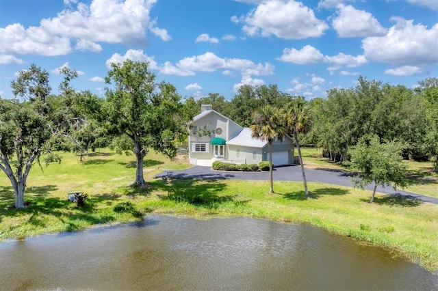 919 Palm View Way, Sarasota, FL 34240 - rear view of house featuring a yard, asphalt driveway, and a water view