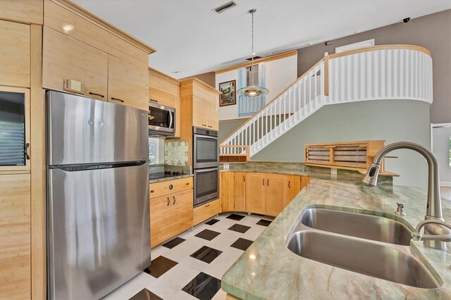 919 Palm View Way, Sarasota, FL 34240 - kitchen featuring appliances with stainless steel finishes, a sink, light brown cabinetry, and light flooring