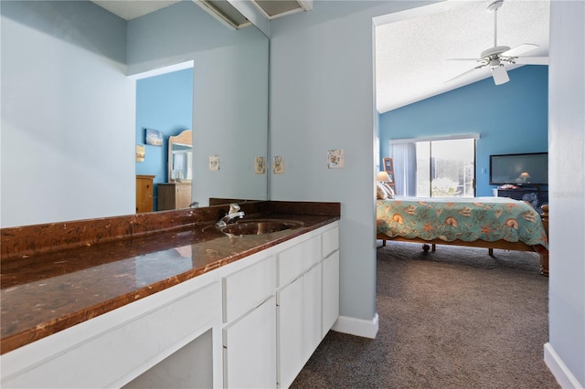 4203 Carriage Dr Unit 27, Sarasota, FL 34241 - ensuite bathroom with lofted ceiling, ceiling fan, vanity, and baseboards