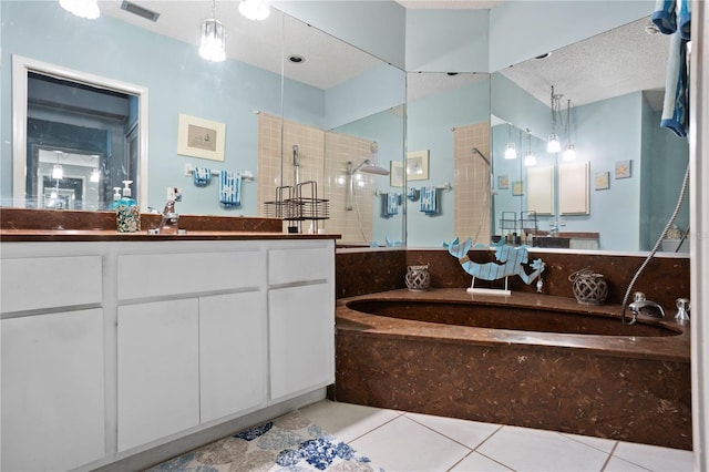 4203 Carriage Dr Unit 27, Sarasota, FL 34241 - bathroom featuring a stall shower, tile patterned floors, a garden tub, vanity, and a textured ceiling