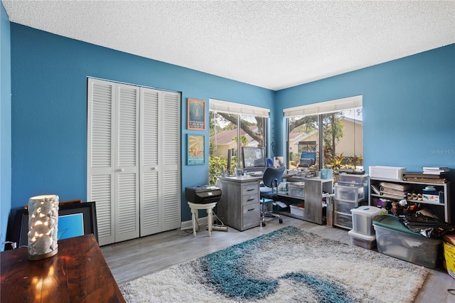4203 Carriage Dr Unit 27, Sarasota, FL 34241 - office with a textured ceiling and wood finished floors