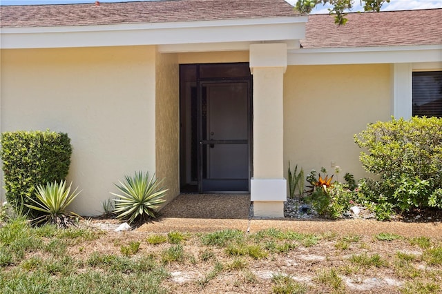4203 Carriage Dr Unit 27, Sarasota, FL 34241 - property entrance with stucco siding and roof with shingles