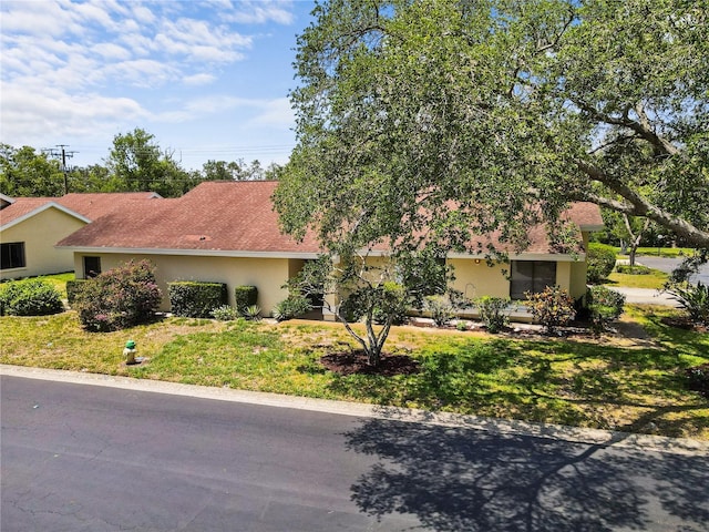 4203 Carriage Dr Unit 27, Sarasota, FL 34241 - view of front of house featuring stucco siding and a front yard