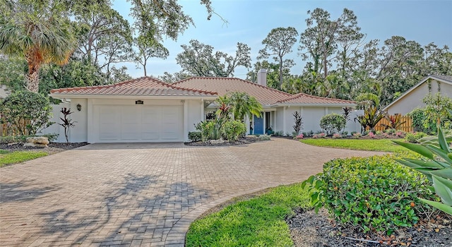 4665 Pine Harrier Dr, Sarasota, FL 34231 - view of front of house featuring decorative driveway, stucco siding, a garage, and a tile roof