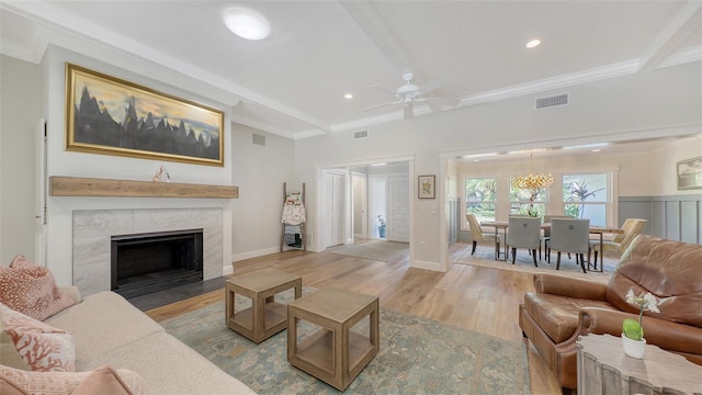4665 Pine Harrier Dr, Sarasota, FL 34231 - living room with light wood-style floors, a ceiling fan, recessed lighting, ornamental molding, and a fireplace