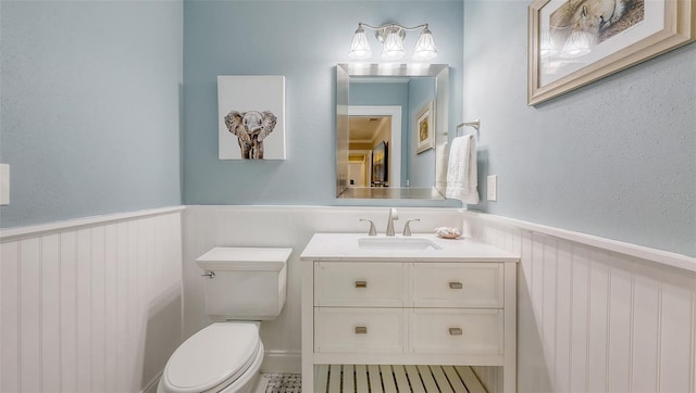 4665 Pine Harrier Dr, Sarasota, FL 34231 - bathroom featuring a wainscoted wall, toilet, and vanity