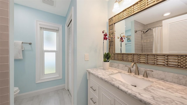 4665 Pine Harrier Dr, Sarasota, FL 34231 - full bathroom featuring vanity, toilet, baseboards, and curtained shower