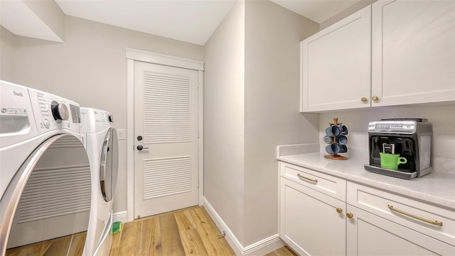 4665 Pine Harrier Dr, Sarasota, FL 34231 - washroom featuring light wood-type flooring, washer and dryer, cabinet space, and baseboards