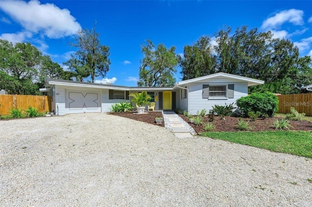ranch-style home featuring driveway and an attached garage