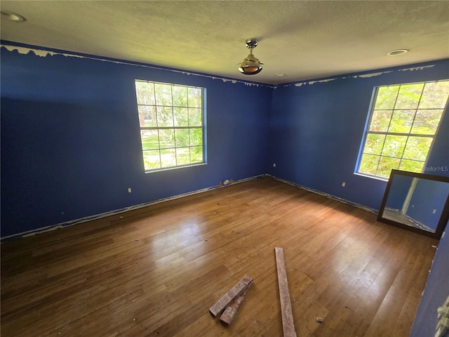 2905 Sunset Rd, Melbourne, FL 32904 - spare room featuring wood-type flooring, baseboards, and a textured ceiling