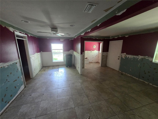 2905 Sunset Rd, Melbourne, FL 32904 - tiled empty room featuring a wainscoted wall and ceiling fan