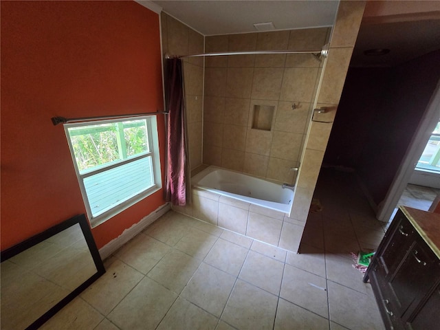 2905 Sunset Rd, Melbourne, FL 32904 - bathroom with tiled shower / bath combo, tile patterned floors, and baseboards