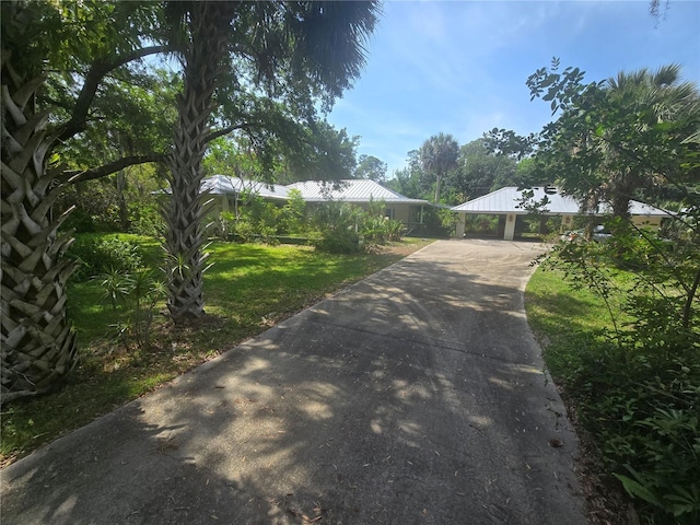 2905 Sunset Rd, Melbourne, FL 32904 - view of front of property with driveway, metal roof, and a front yard