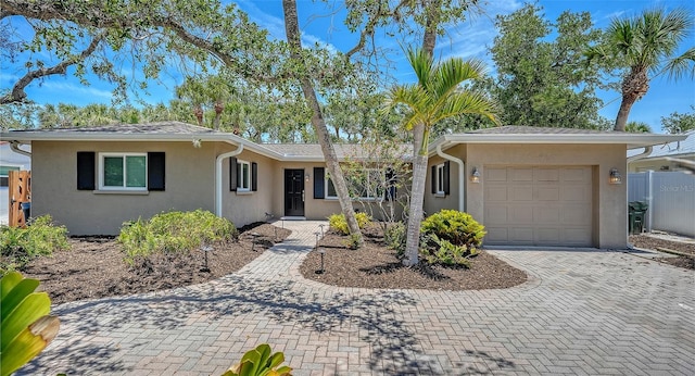 755 Edgemere Ln, Sarasota, FL 34242 - ranch-style home featuring stucco siding, an attached garage, and decorative driveway