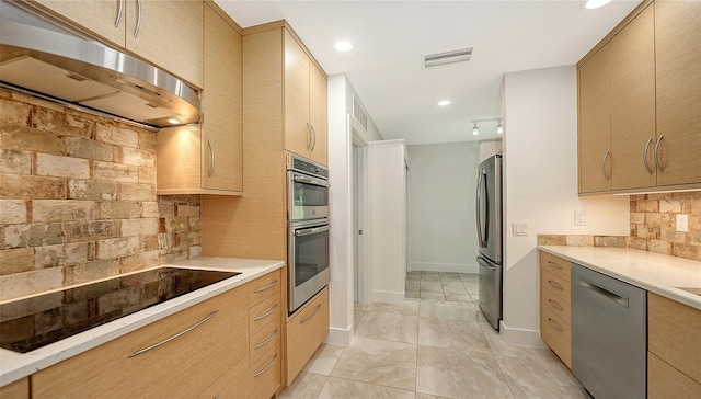 755 Edgemere Ln, Sarasota, FL 34242 - kitchen with stainless steel appliances, under cabinet range hood, decorative backsplash, light countertops, and light brown cabinetry