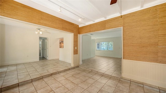 755 Edgemere Ln, Sarasota, FL 34242 - unfurnished room featuring a ceiling fan, rail lighting, light tile patterned floors, and a wainscoted wall