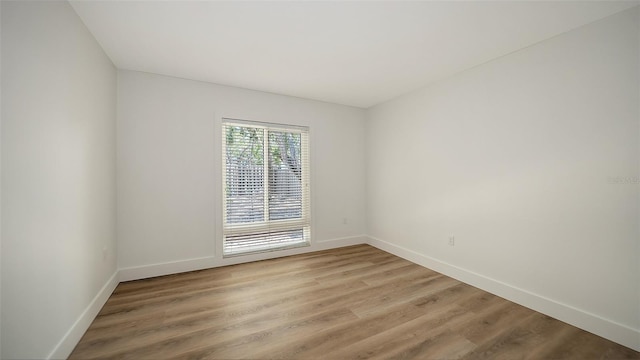 755 Edgemere Ln, Sarasota, FL 34242 - unfurnished room featuring baseboards and light wood-type flooring